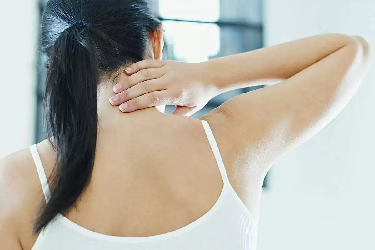 a woman holding her neck