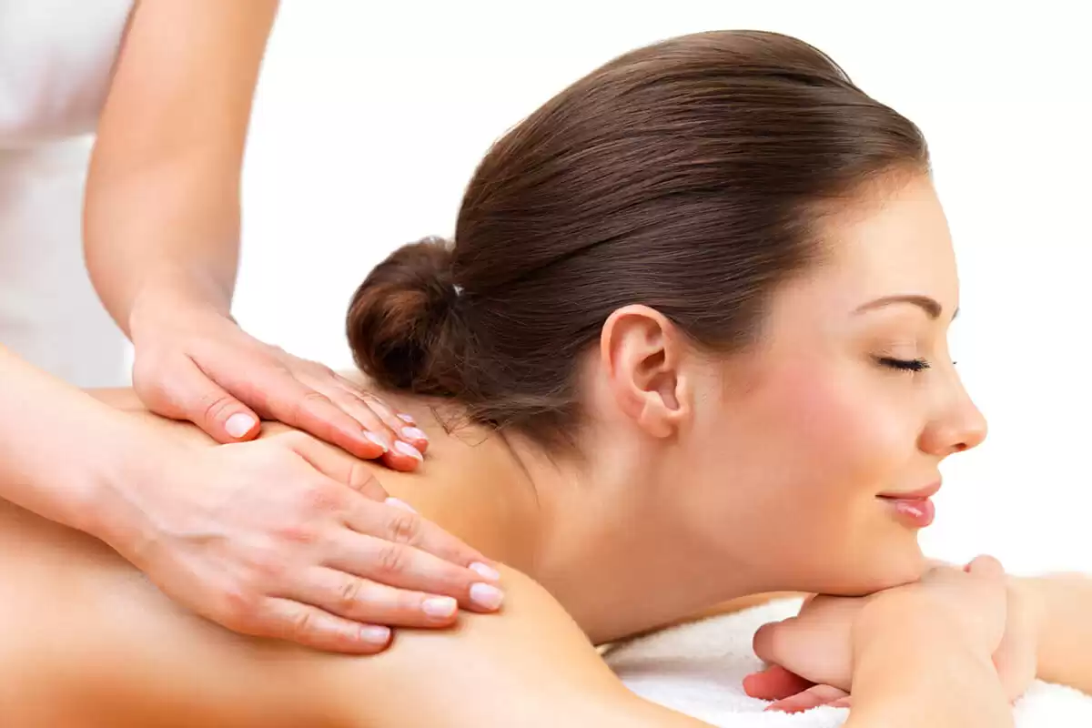 a woman lying down on a towel with her eyes closed